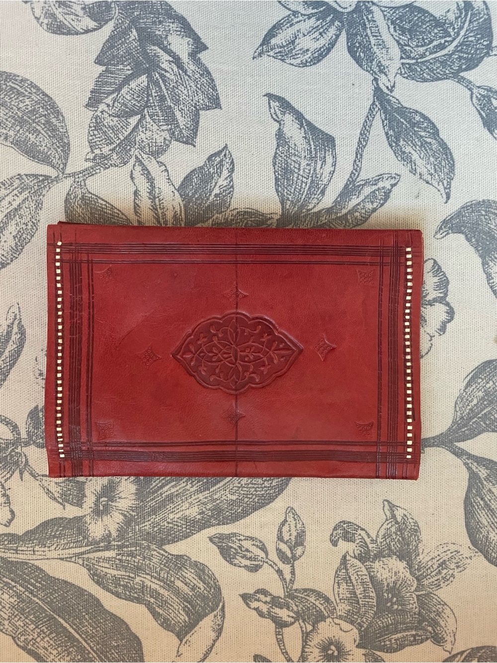 Red Embossed Leather Wallet with Decorative Medallion
